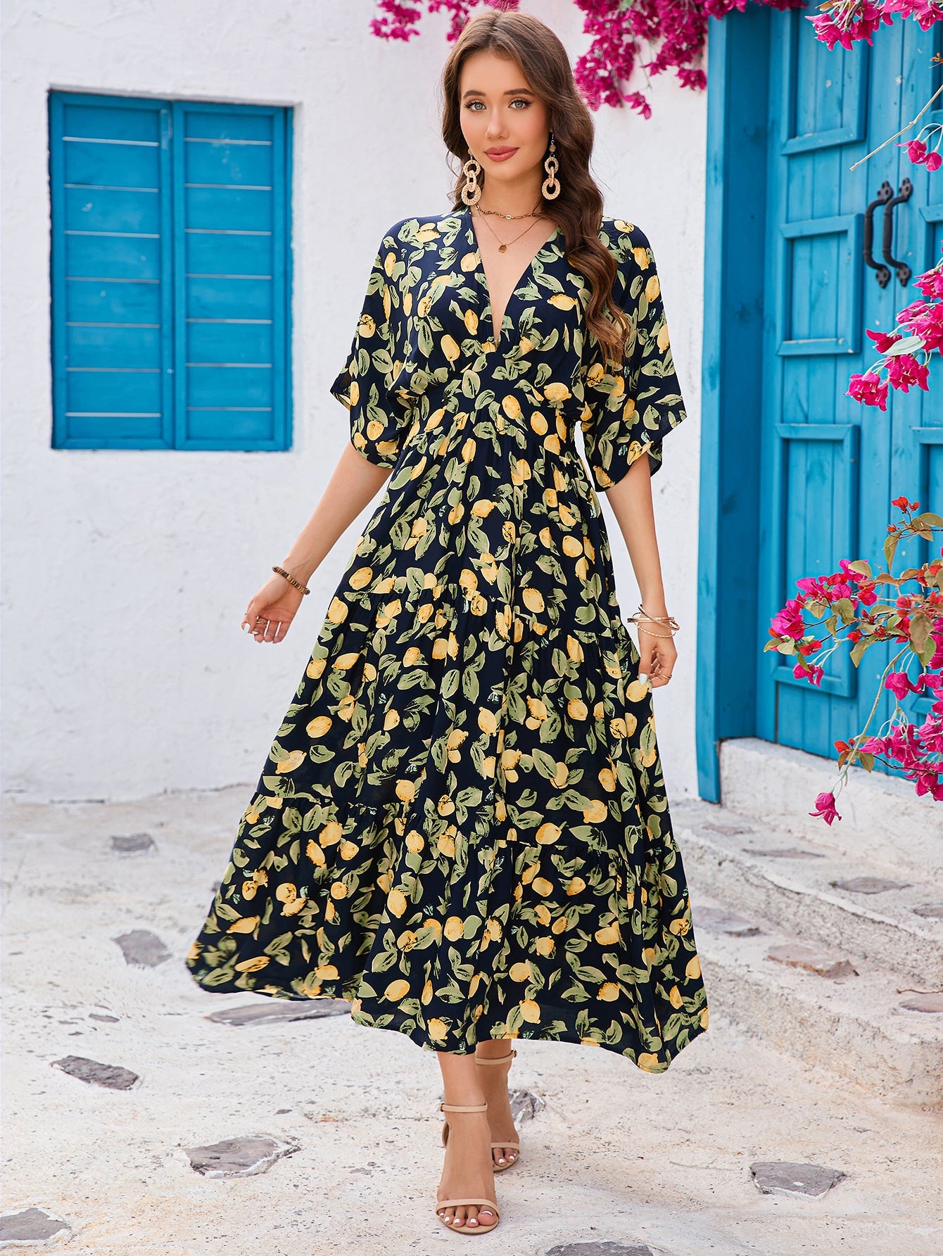 Elegant green embroidered maxi dress for women with gold floral patterns and sheer flowing sleeves