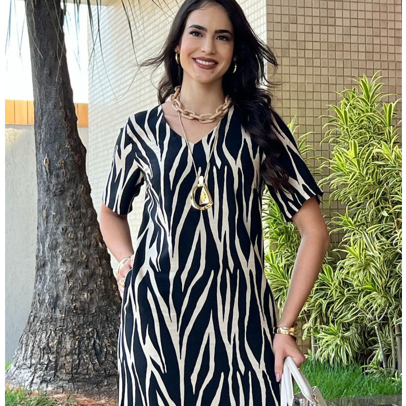 Elegant V-Neck Printed Maxi Dress with Pockets in - by Malbusaat