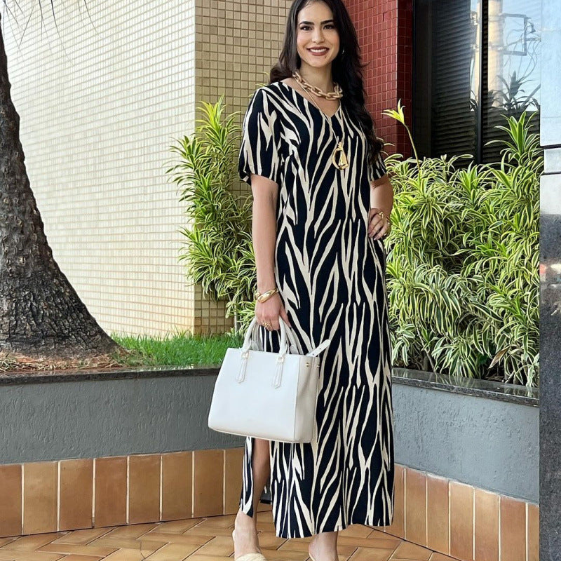 Elegant V-Neck Printed Maxi Dress with Pockets in - by Malbusaat