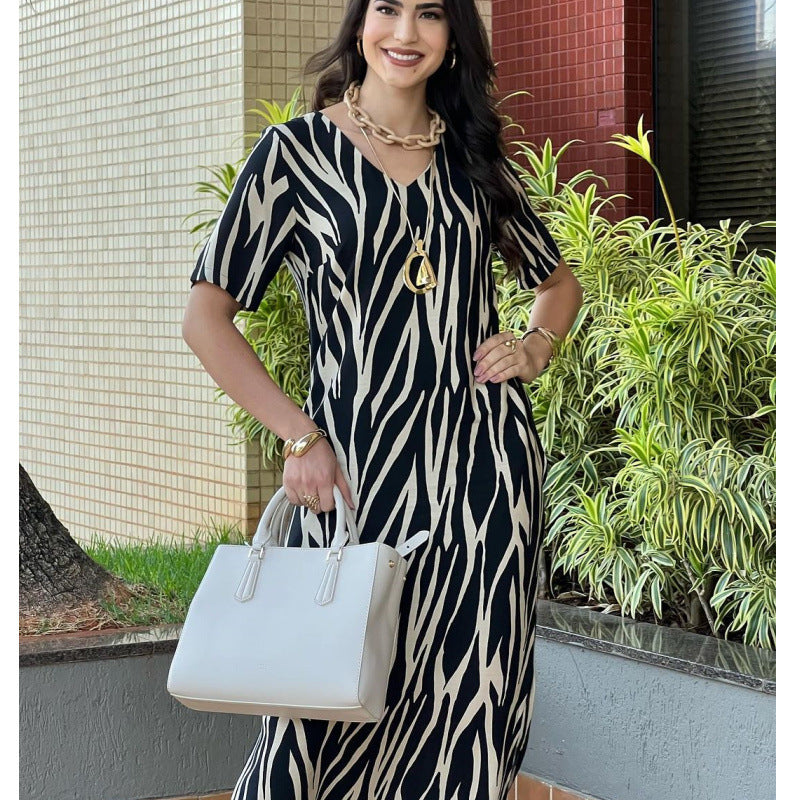Elegant V-Neck Printed Maxi Dress with Pockets in - by Malbusaat