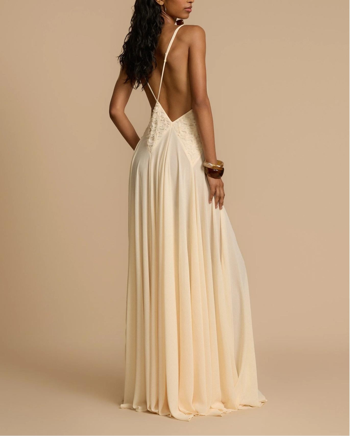 Elegant lace maxi dress in cream with delicate straps and flowing skirt by Malbusaat