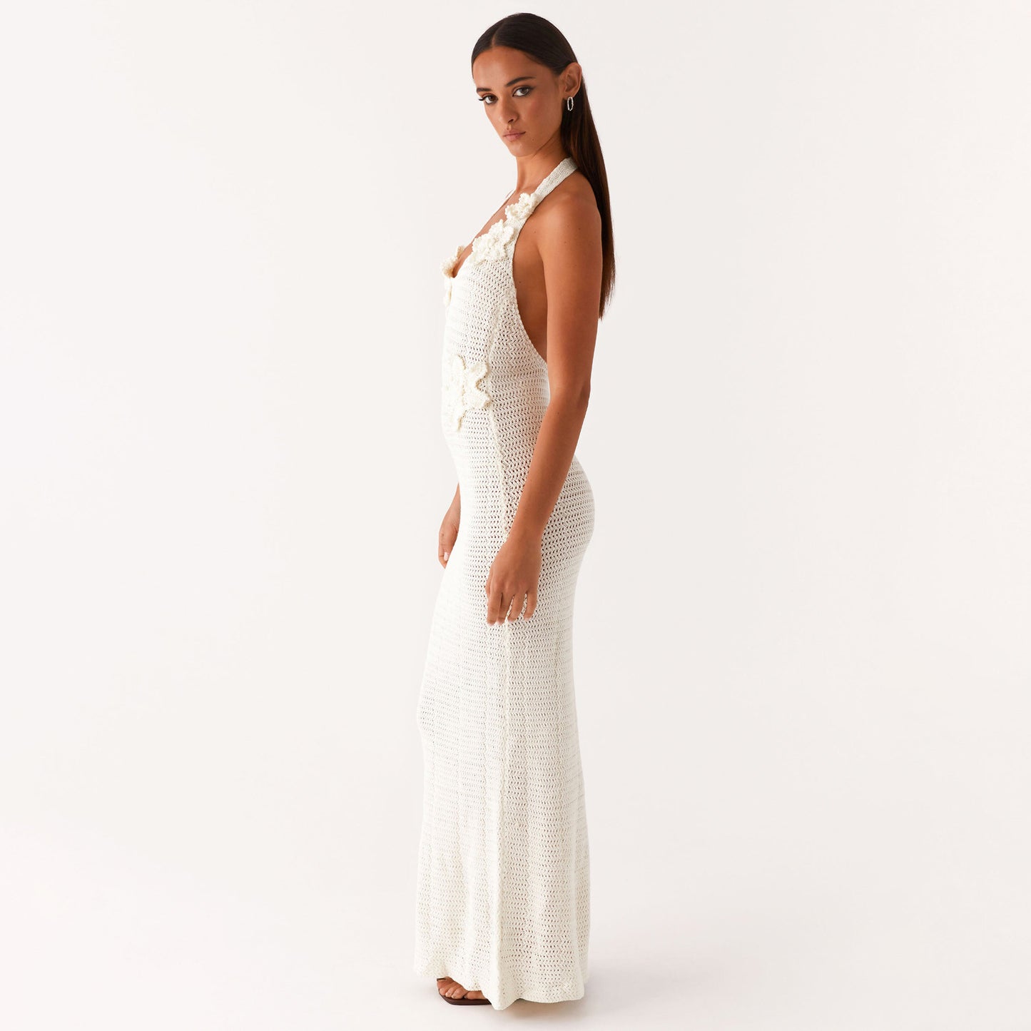 Malbusaat white halter knit floral cutout maxi dress with side flower appliques model profile view