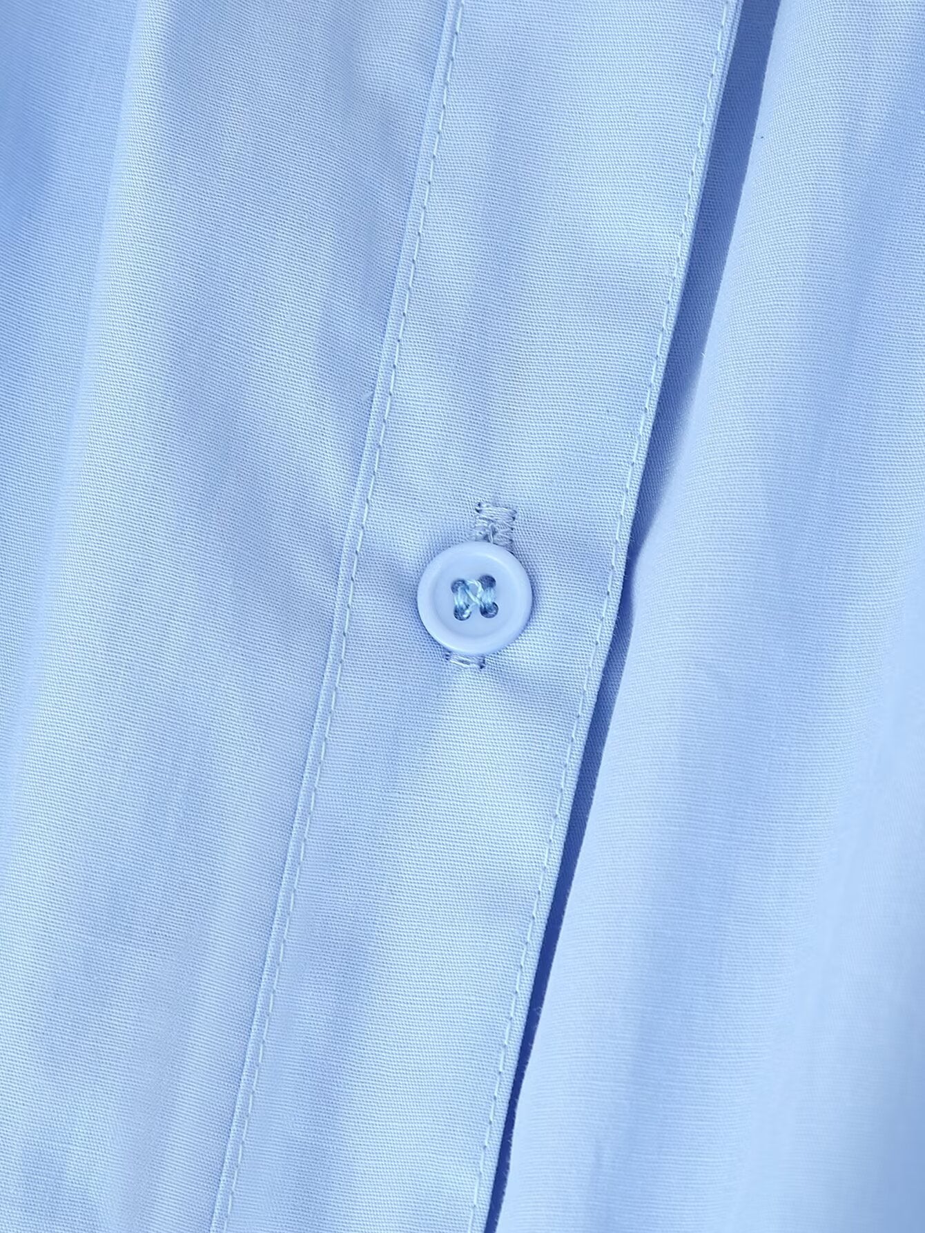 Close up of light blue button placket detail on Malbusaat puff sleeve round neck maxi dress fabric