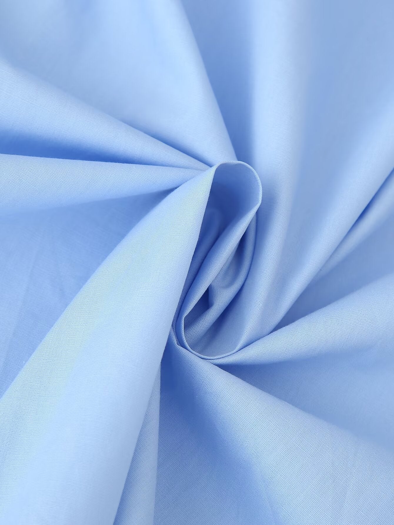 Malbusaat light blue cotton fabric close up swirl showing texture for puff sleeve round neck maxi dress