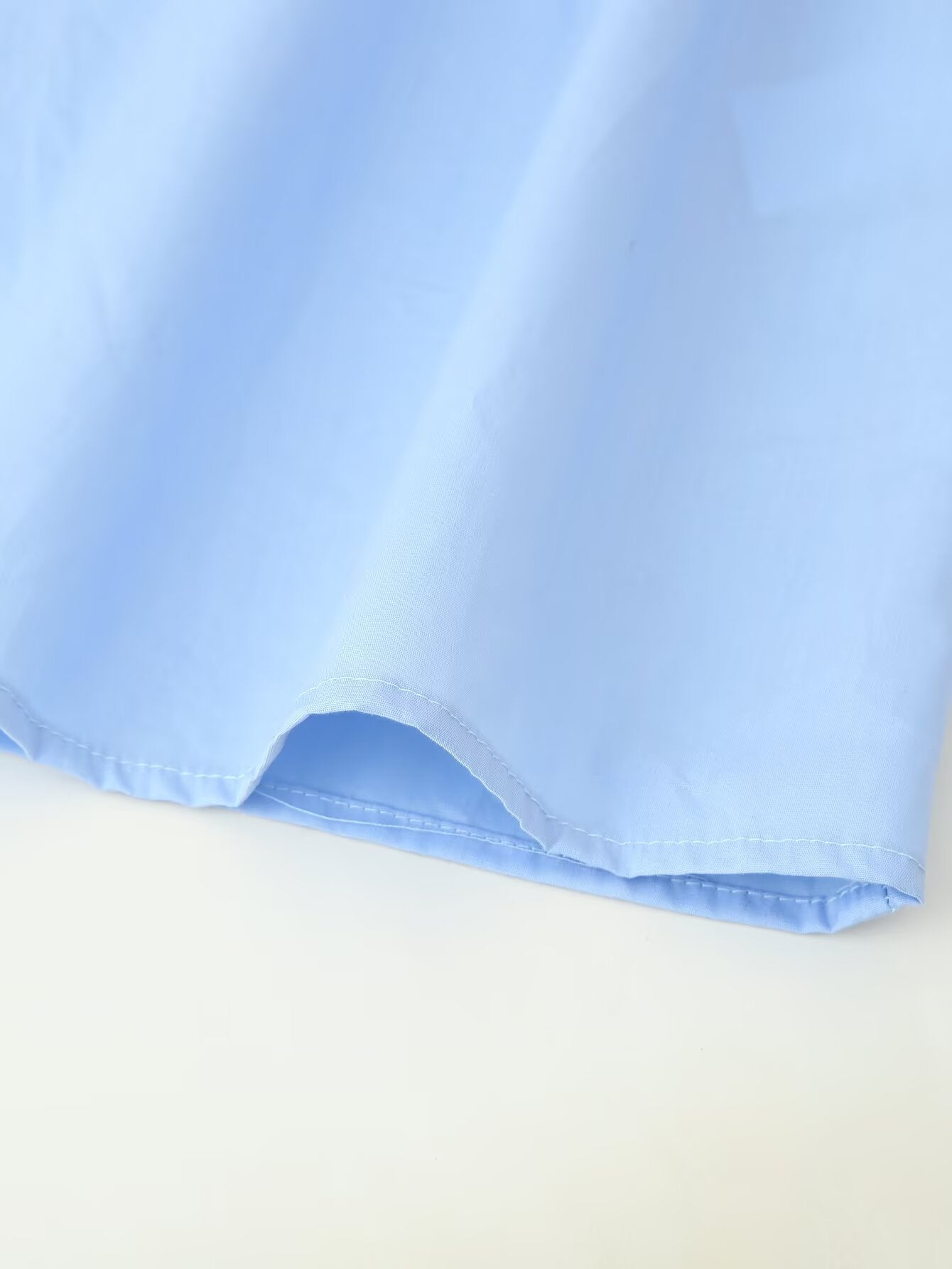 Light blue cotton puff sleeve round neck maxi dress hem detail by Malbusaat showing soft drape