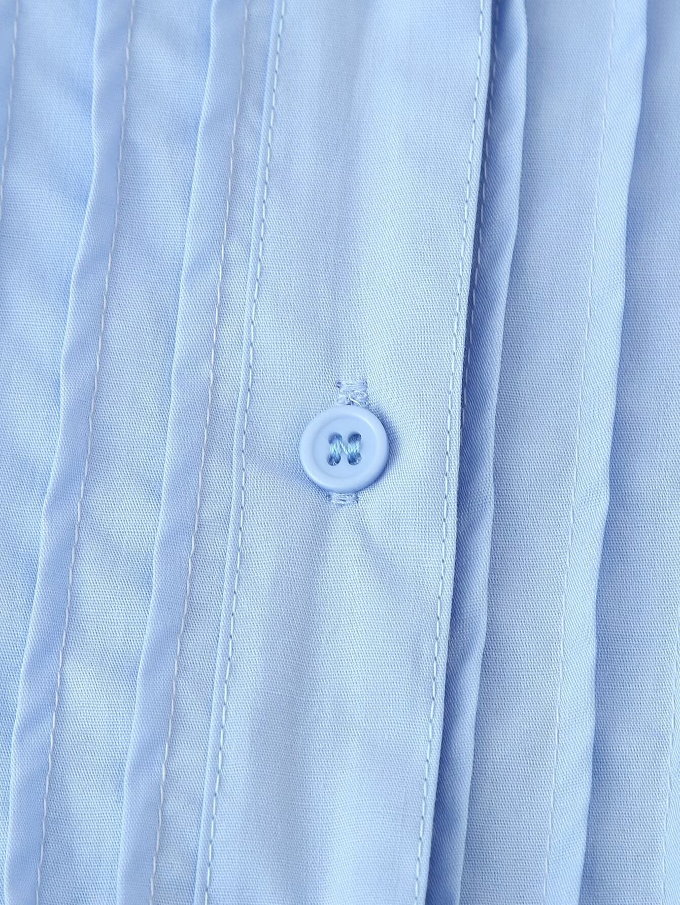 Light blue cotton dress close up showing pleated front and button detail for puff sleeve round neck maxi