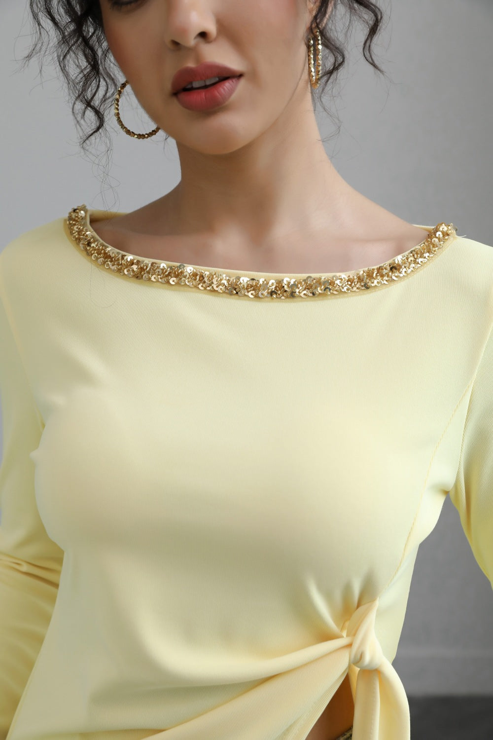 Malbusaat autumn lace up top pale yellow with gold beaded boat neckline and side knot tie on model