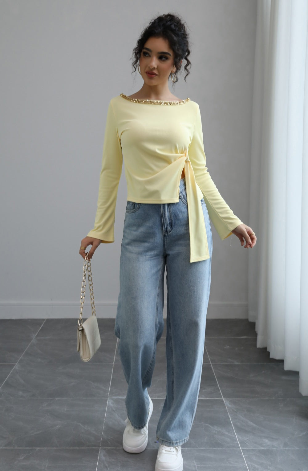 Malbusaat autumn lace up top pale yellow long sleeve with side tie and embellished neckline worn with wide leg jeans