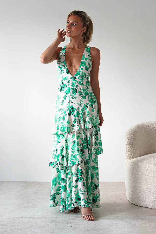 Woman wearing a Backless Deep V Plunge Summer Vacation Maxi dress with green floral print and layered skirt