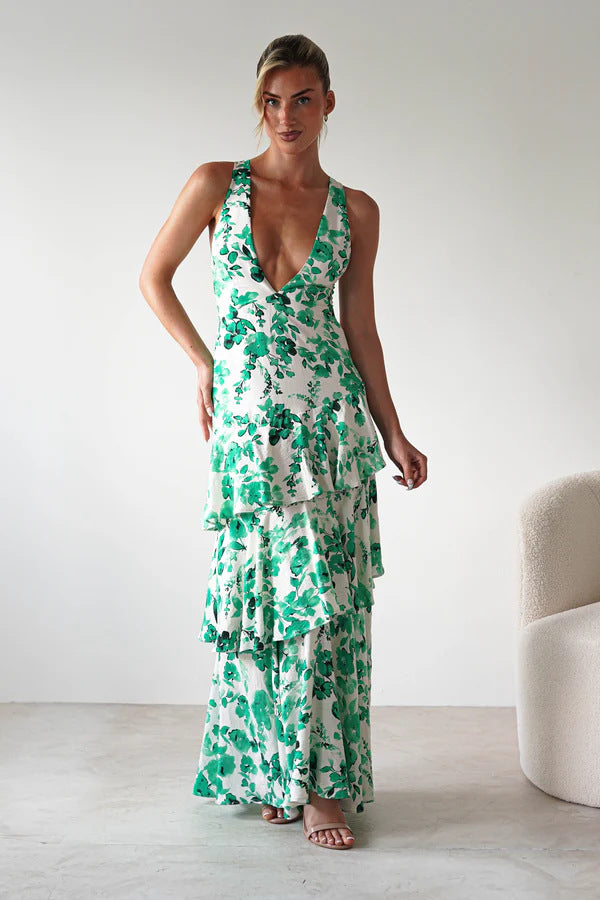 Backless Deep V Plunge Summer Vacation Maxi dress with green floral print worn by model standing indoors