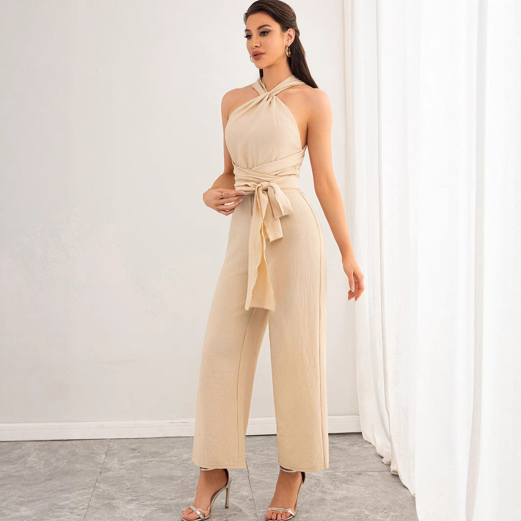Malbusaat beige halter tied waist backless women's jumpsuit with wide leg trousers modelled in studio