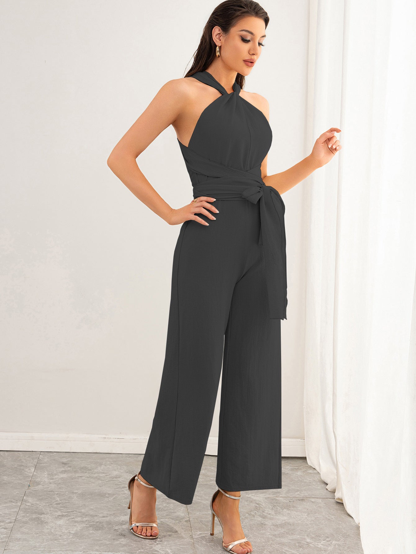 Malbusaat backless women's jumpsuit charcoal halter neck with waist tie and wide leg trousers
