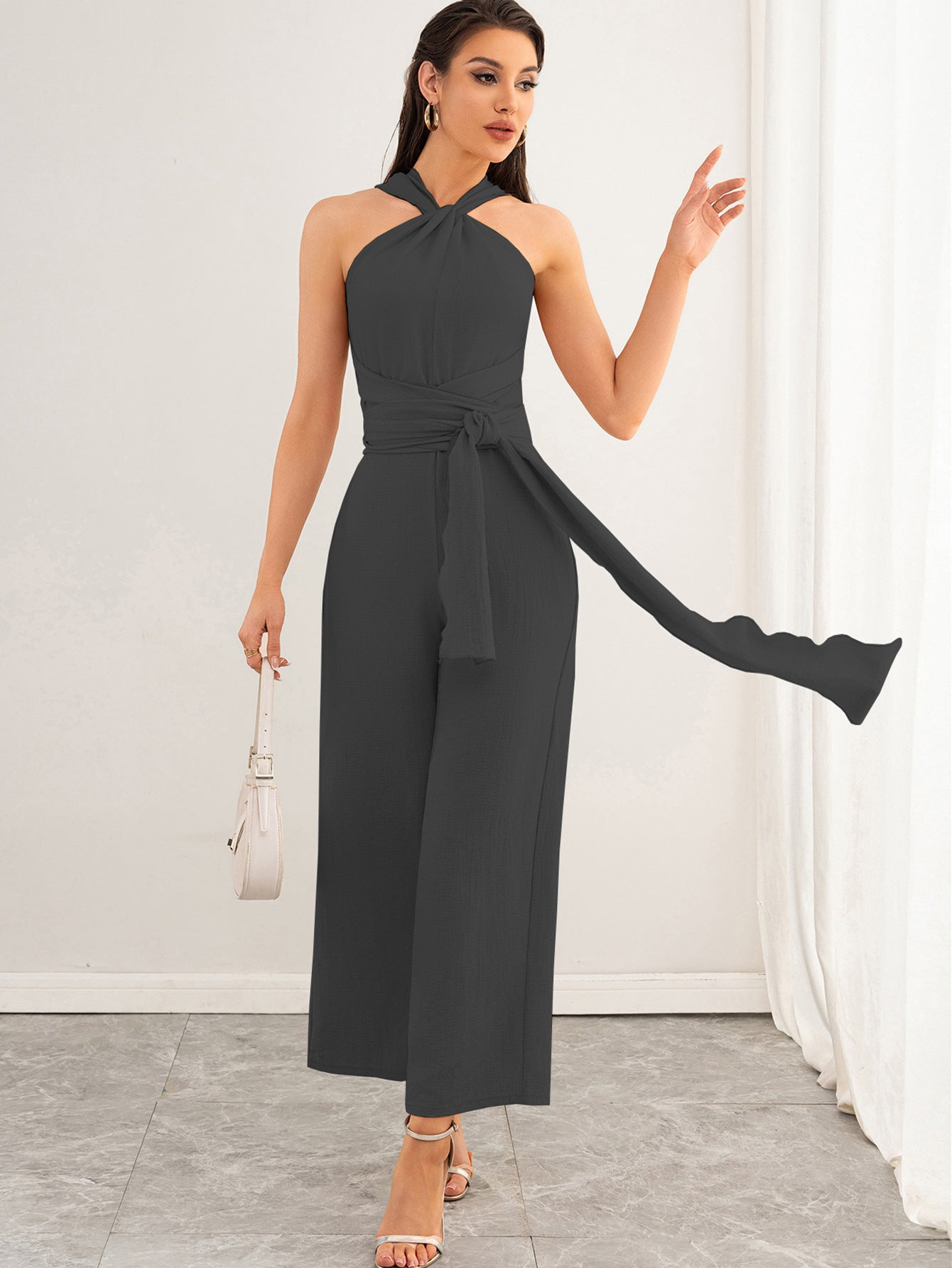 Malbusaat charcoal halter backless women's jumpsuit with waist tie wide cropped legs and white handbag