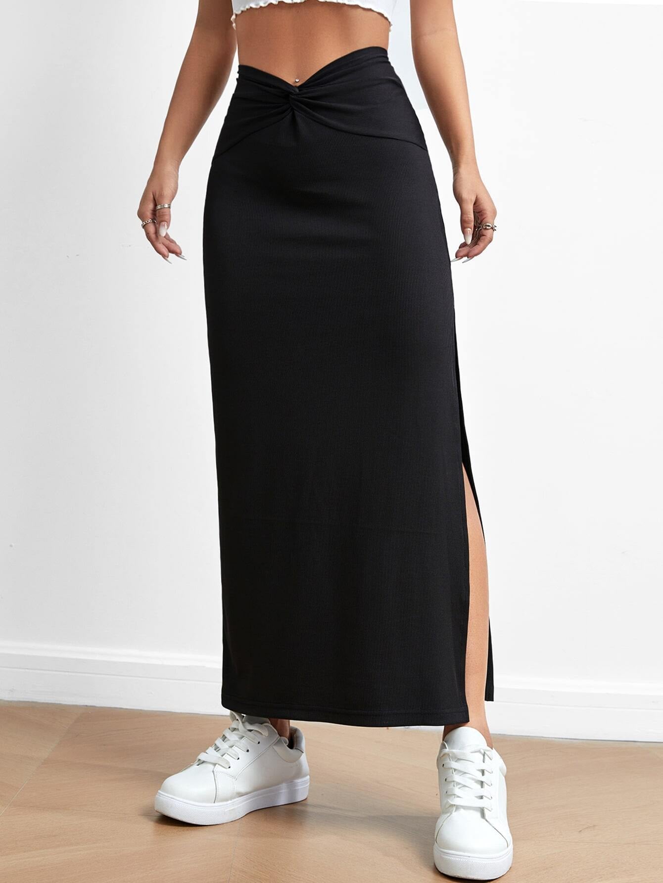 Black Malbusaat drape slit skirt with knot detail and side slit worn with white sneakers