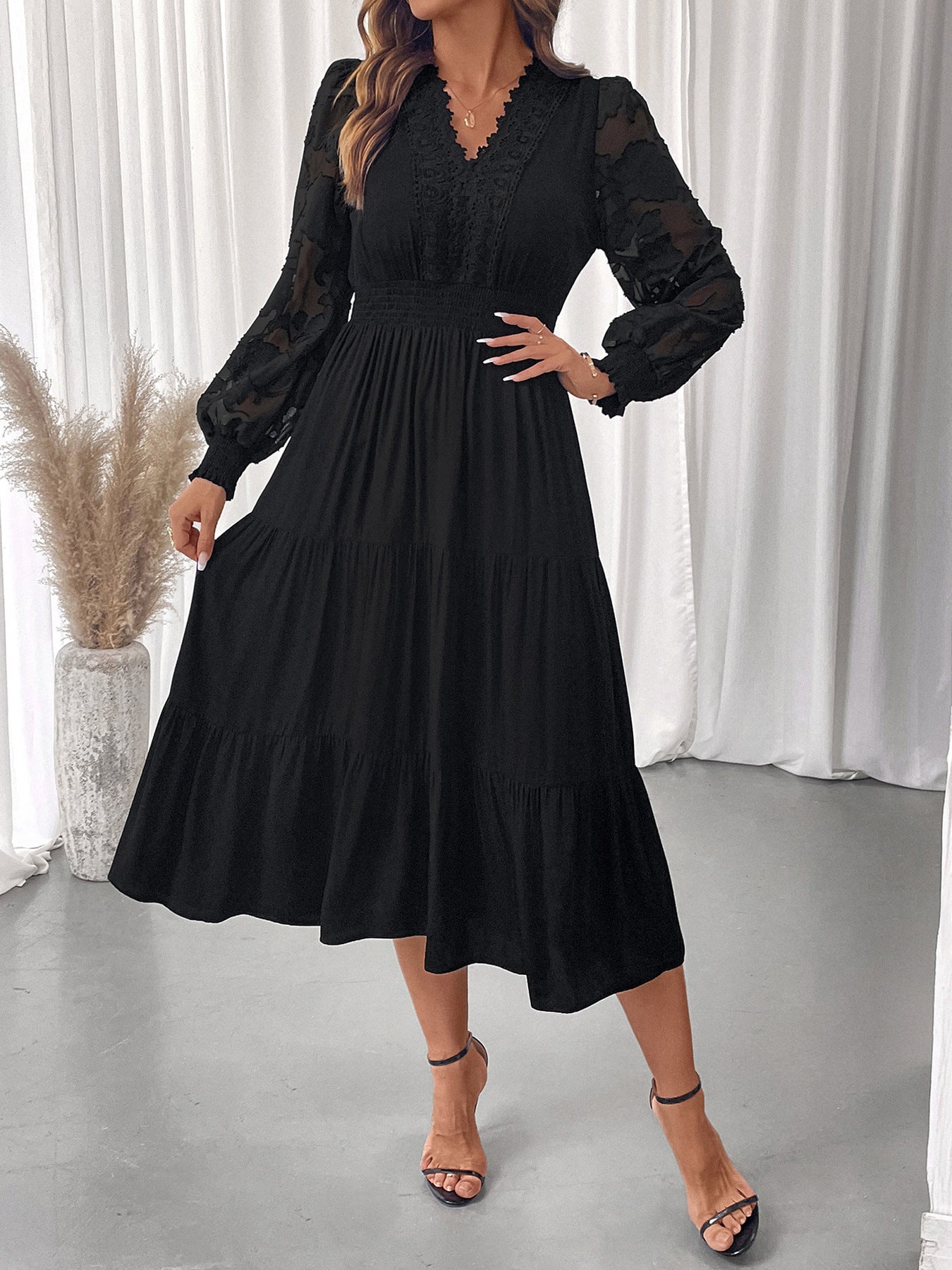 Elegant lace long sleeve dress in black with sheer lace sleeves and tiered skirt by Malbusaat