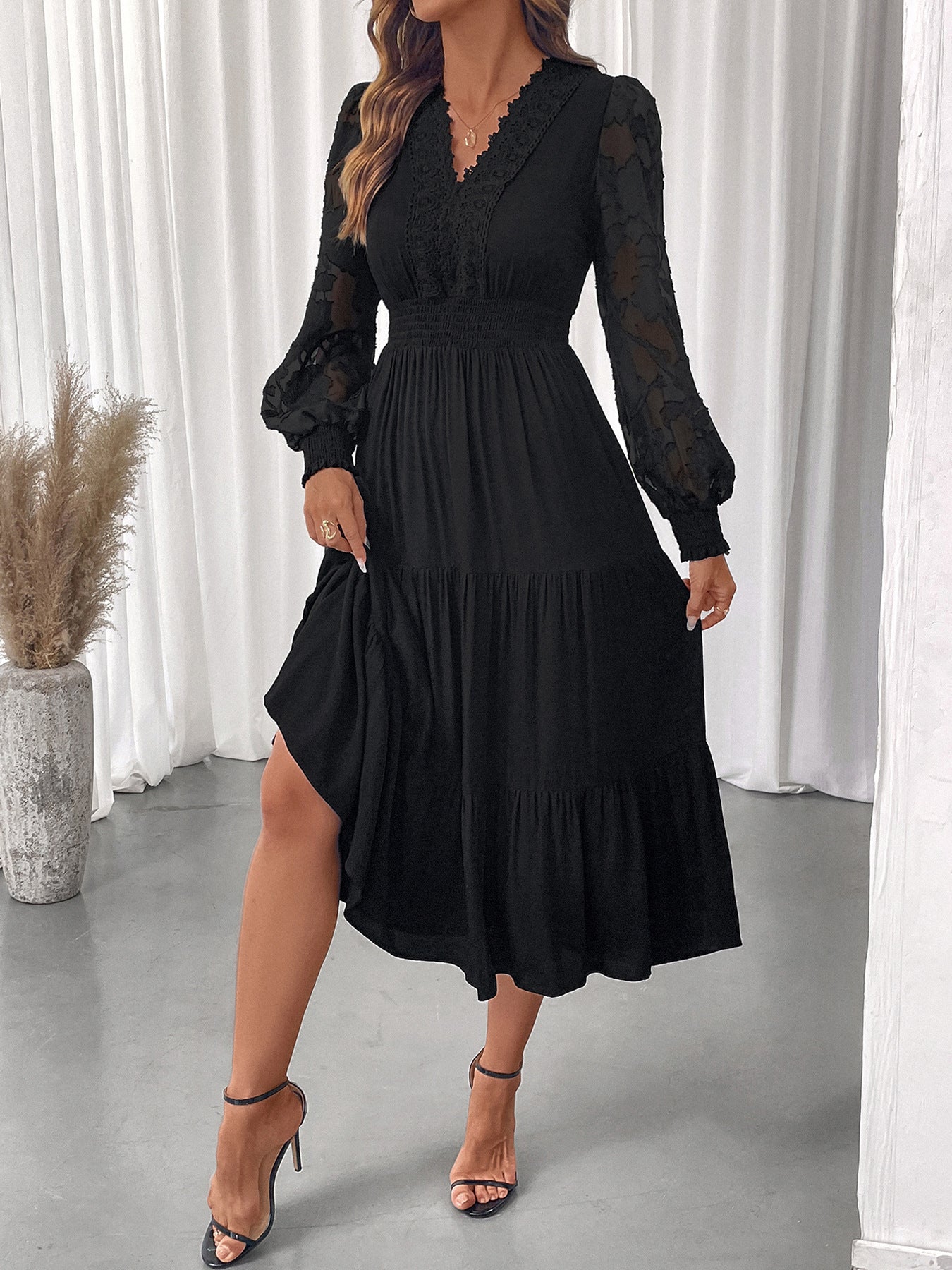 Elegant black elegant lace long sleeve dress with sheer sleeves and tiered skirt by Malbusaat