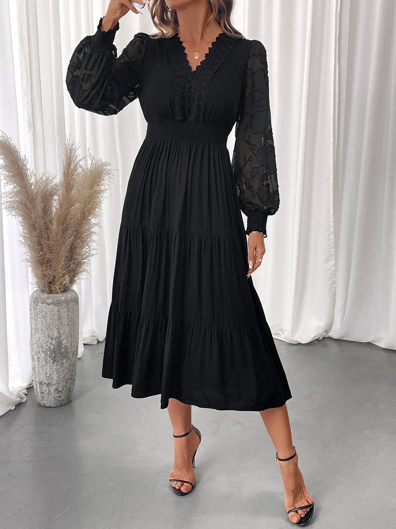 Elegant lace long sleeve dress in black with sheer sleeves and tiered skirt by Malbusaat