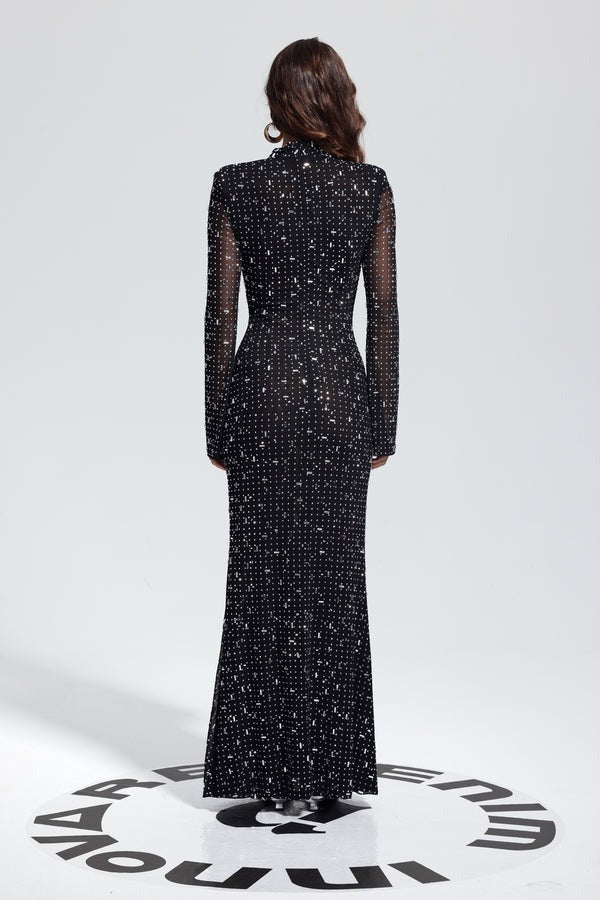 Back view of model in long sleeve black rhinestone bodycon dress with high neck and fitted waist.