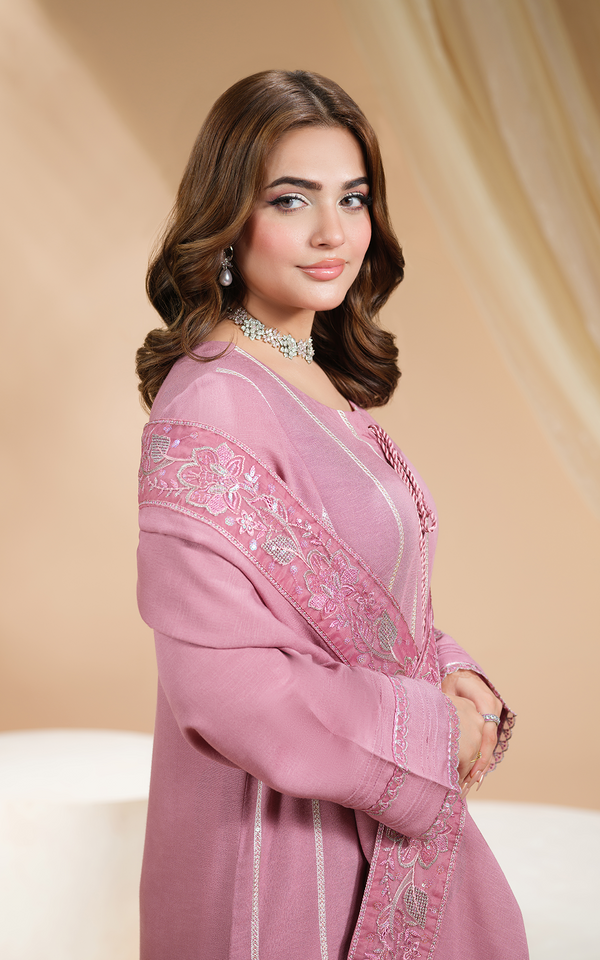 Elegant model wearing a Blush Mauve Embroidered Dhanak Suit with intricate detailing and a stylish shawl