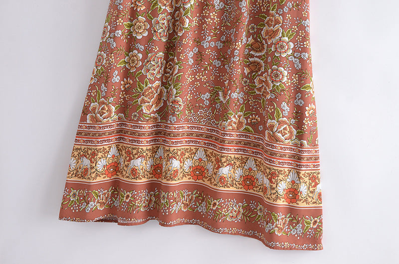 Close-up of Malbusaat bohemian maxi dress for women featuring floral patterns on brown fabric