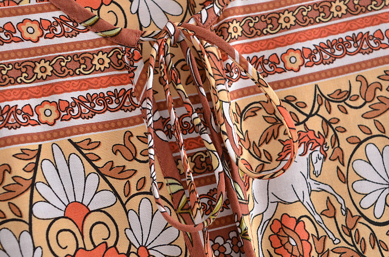 Close-up of Malbusaat bohemian maxi dress for women featuring floral and horse print with tie-up neckline