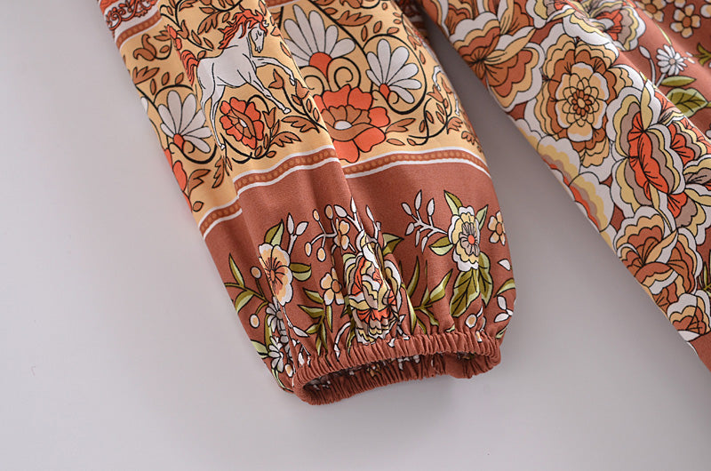 Close-up of sleeve with floral and horse print detail on bohemian maxi dress for women by Malbusaat