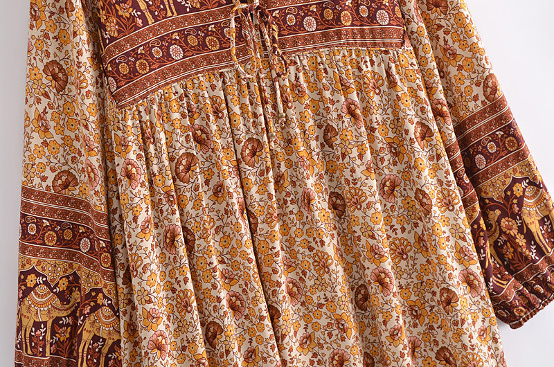 Malbusaat boho floral dress online UK featuring intricate yellow and brown floral and elephant print with long sleeves