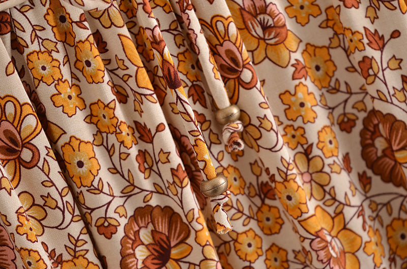 Detailed close-up of Malbusaat boho floral dress online UK with yellow and brown flower print fabric