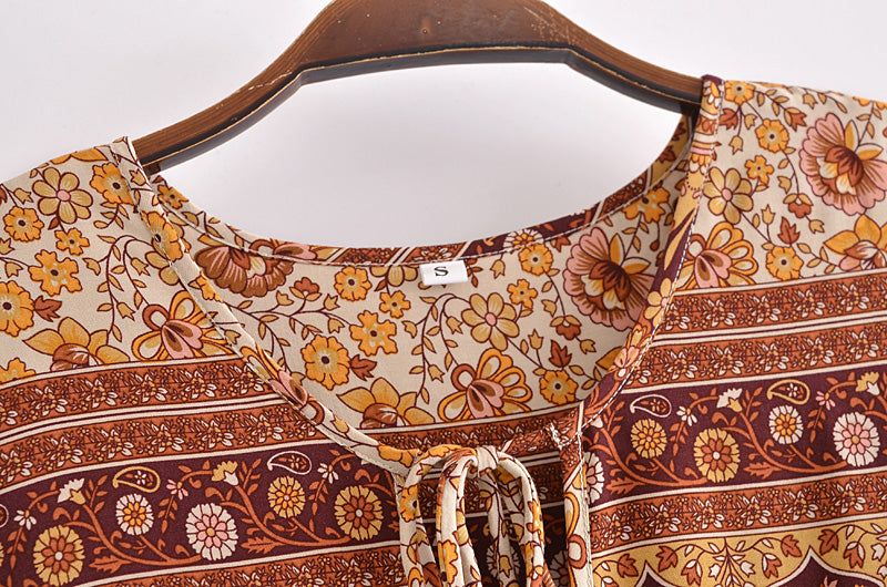 Close-up of Malbusaat boho floral dress online UK with yellow and brown flower patterns on fabric neckline