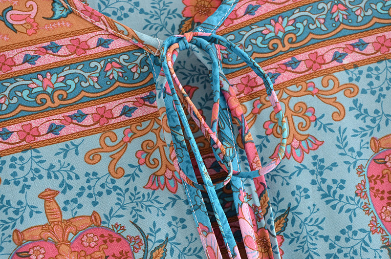 Close-up of lace up crew neck maxi dress for women in blue with floral and decorative patterns by Malbusaat