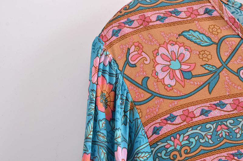 Close-up of colourful floral patterned fabric on Malbusaat lace up crew neck maxi dress for women