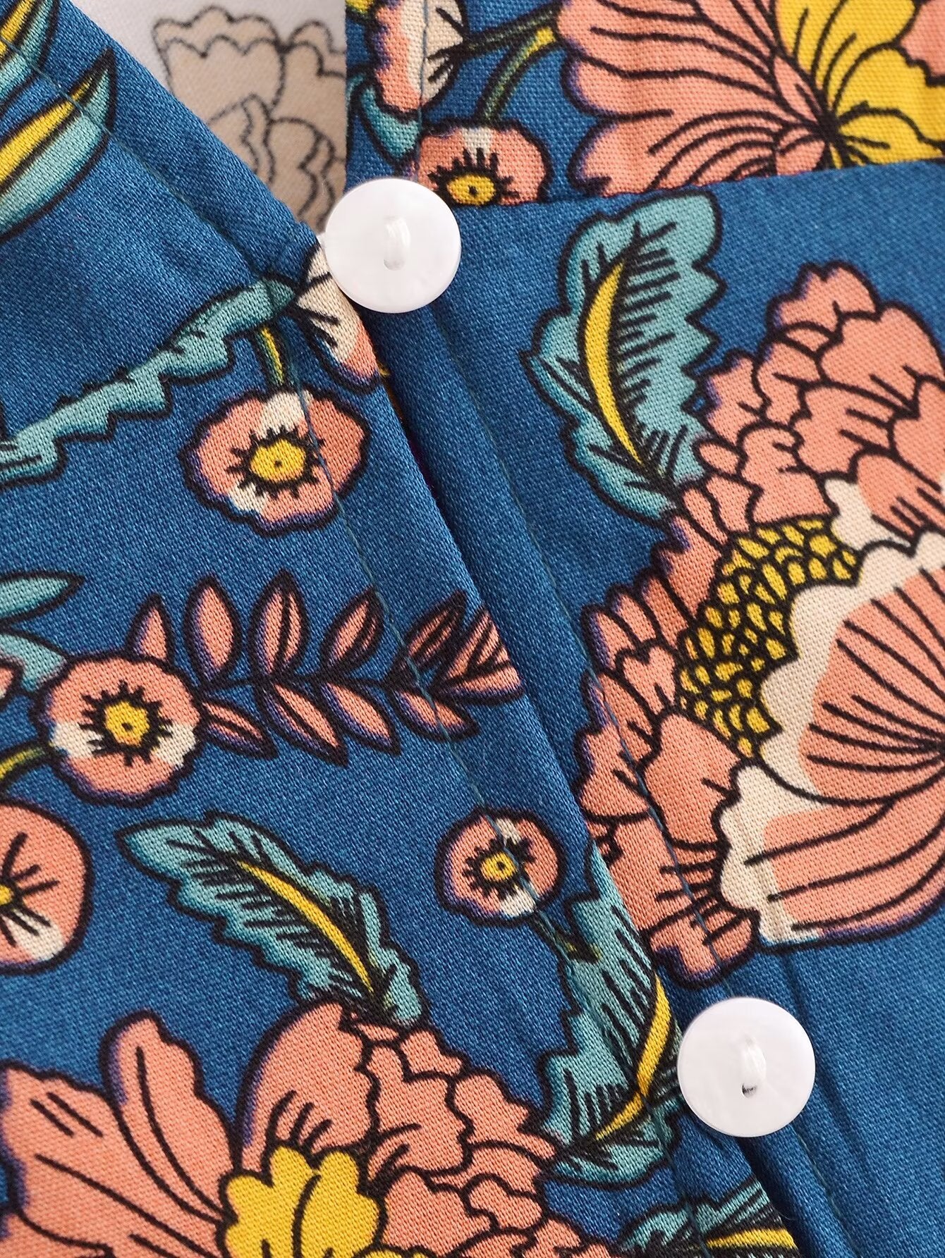 Close-up of Malbusaat long sleeve floral summer dress UK featuring blue fabric with pink and yellow flowers and white buttons