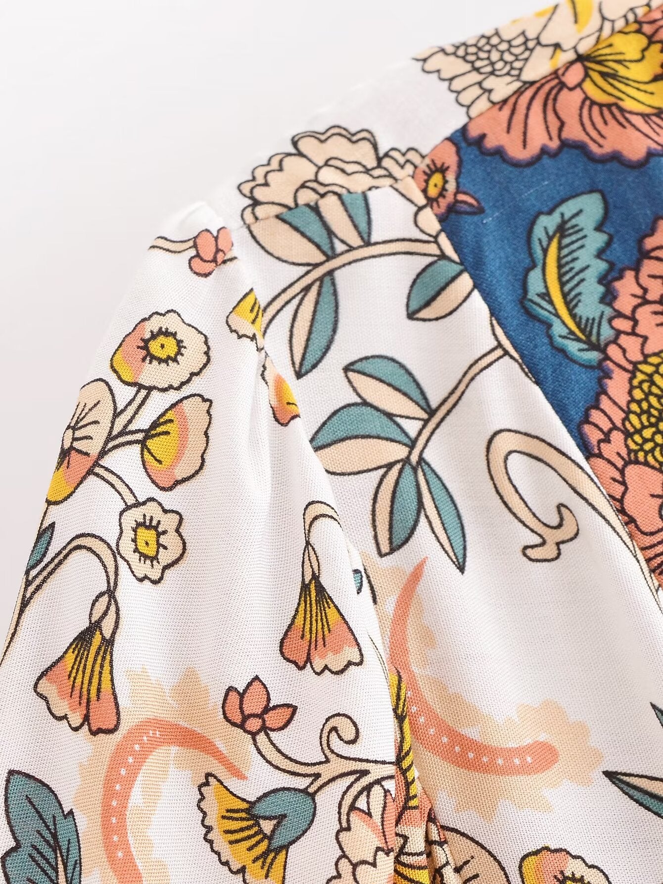 Close-up of Malbusaat long sleeve floral summer dress UK showing detailed multicolour flower patterns on white fabric
