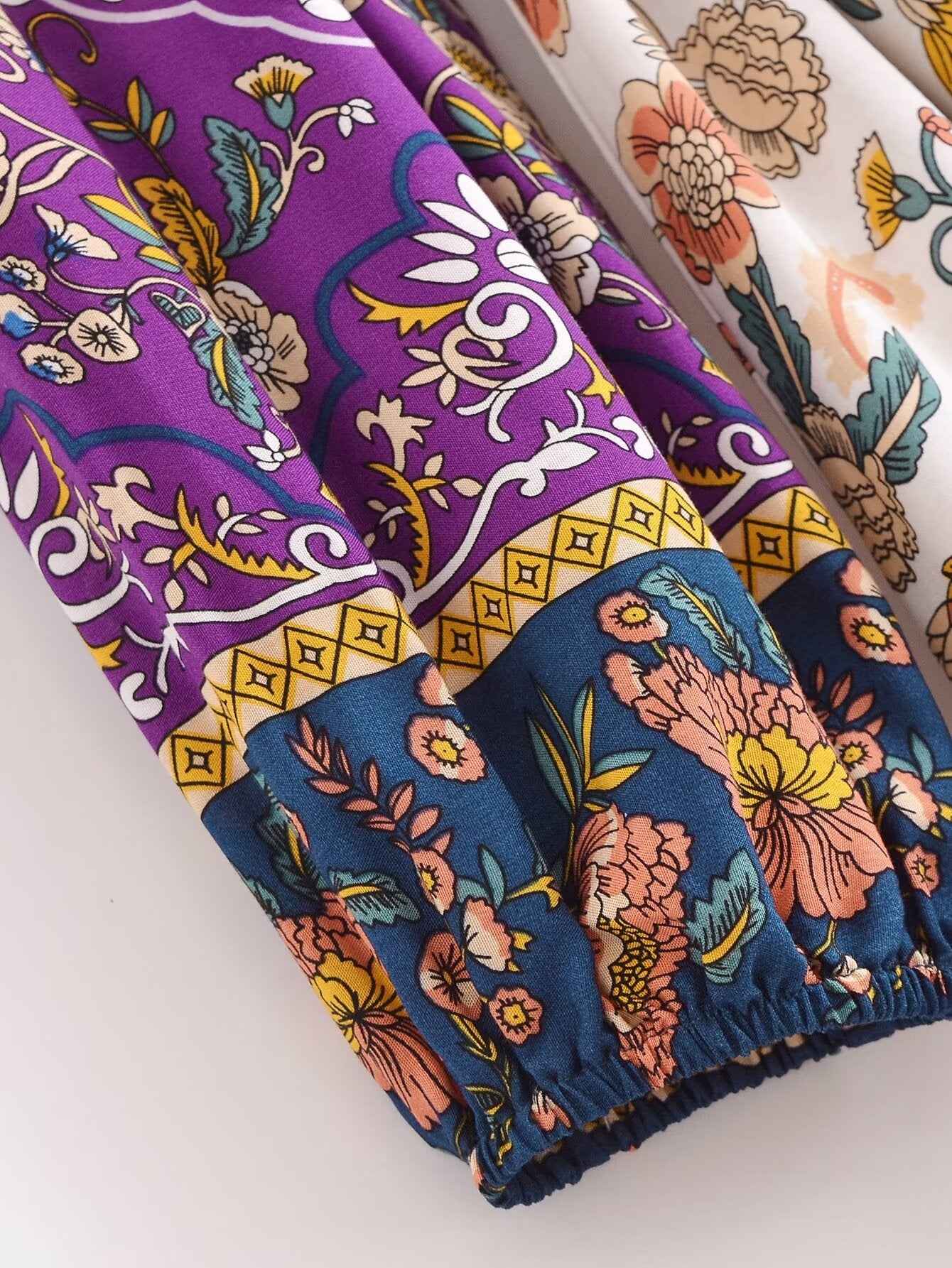 Close-up of long sleeve floral summer dress UK by Malbusaat showing colourful floral patterns and elastic cuff detail