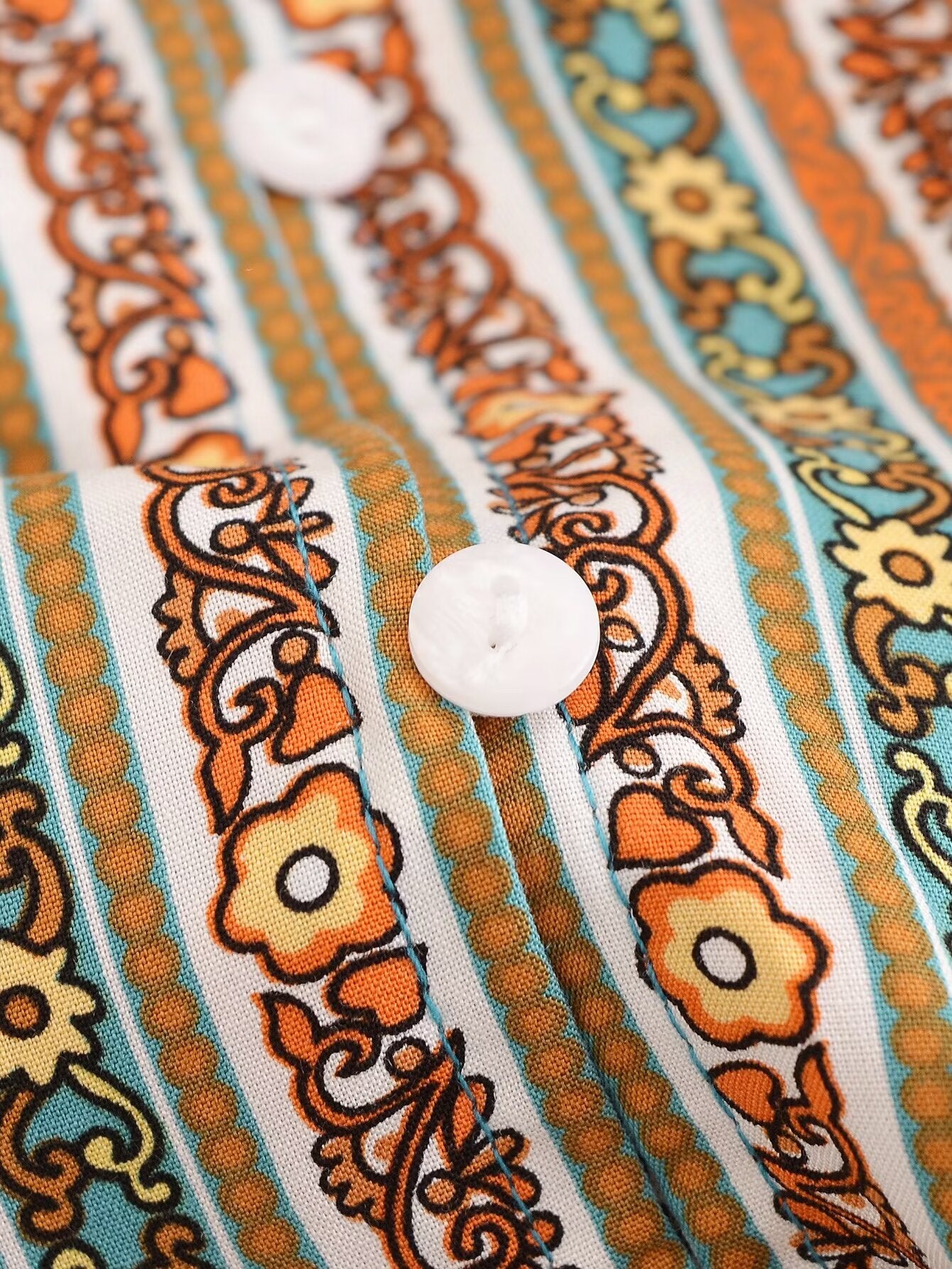 Close-up of Malbusaat rayon floral maxi dress fabric with detailed floral and stripe patterns