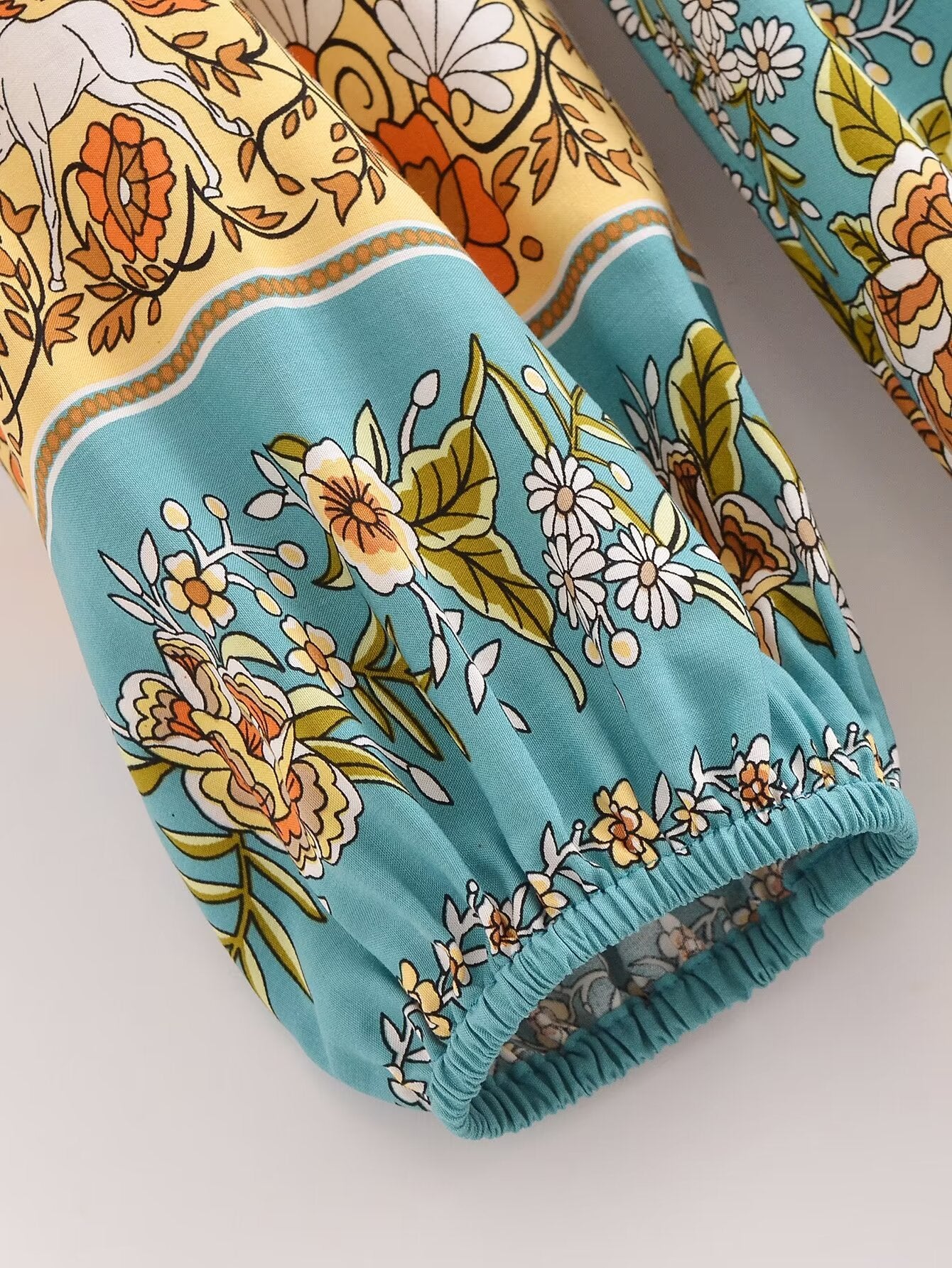 Close-up of sleeve detail on Malbusaat rayon floral maxi dress with colourful floral patterns