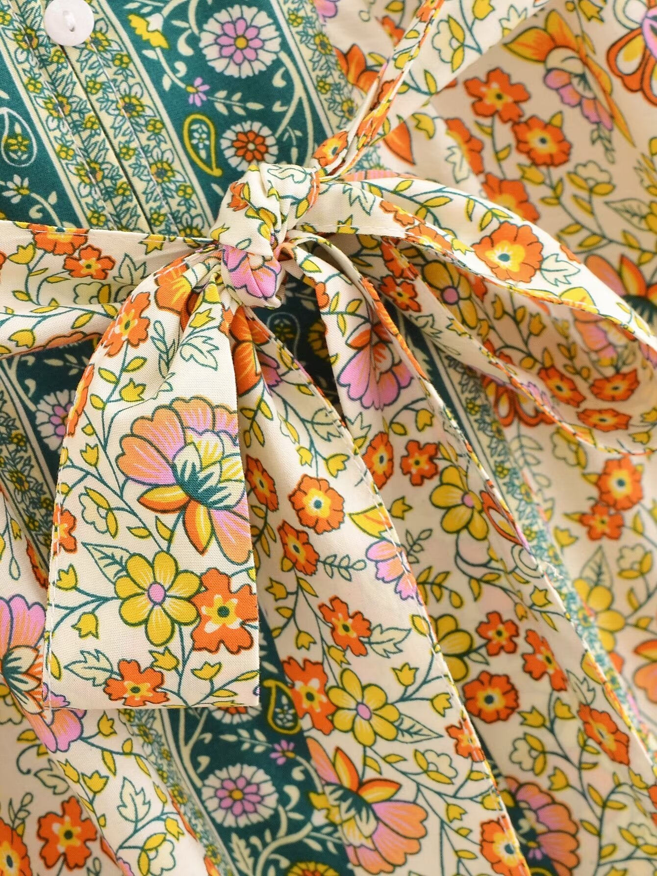 Close-up of Malbusaat rayon floral maxi dress with orange and pink floral print and tied waist detail