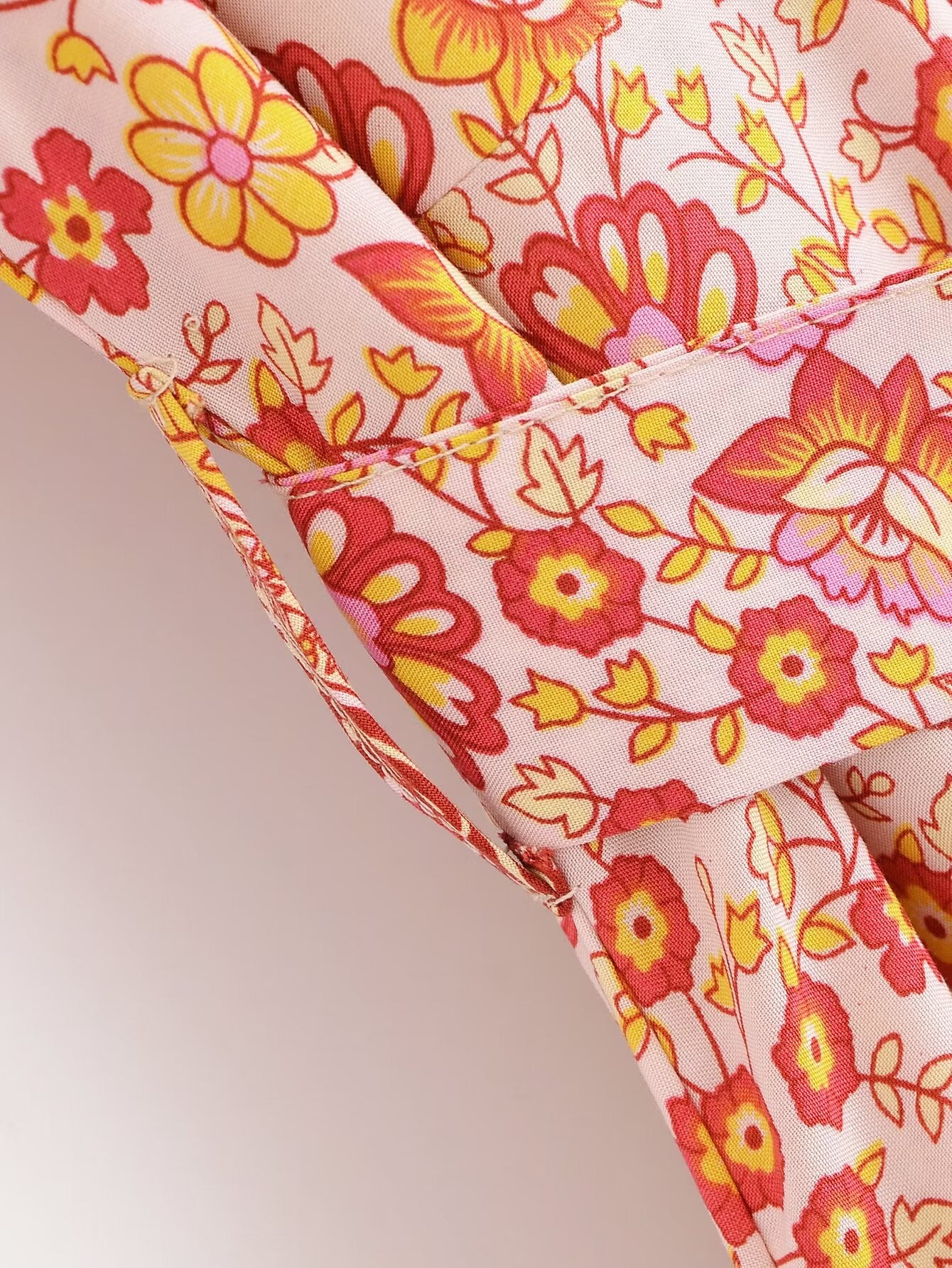 Close-up of Malbusaat rayon floral maxi dress fabric with yellow and red flower pattern
