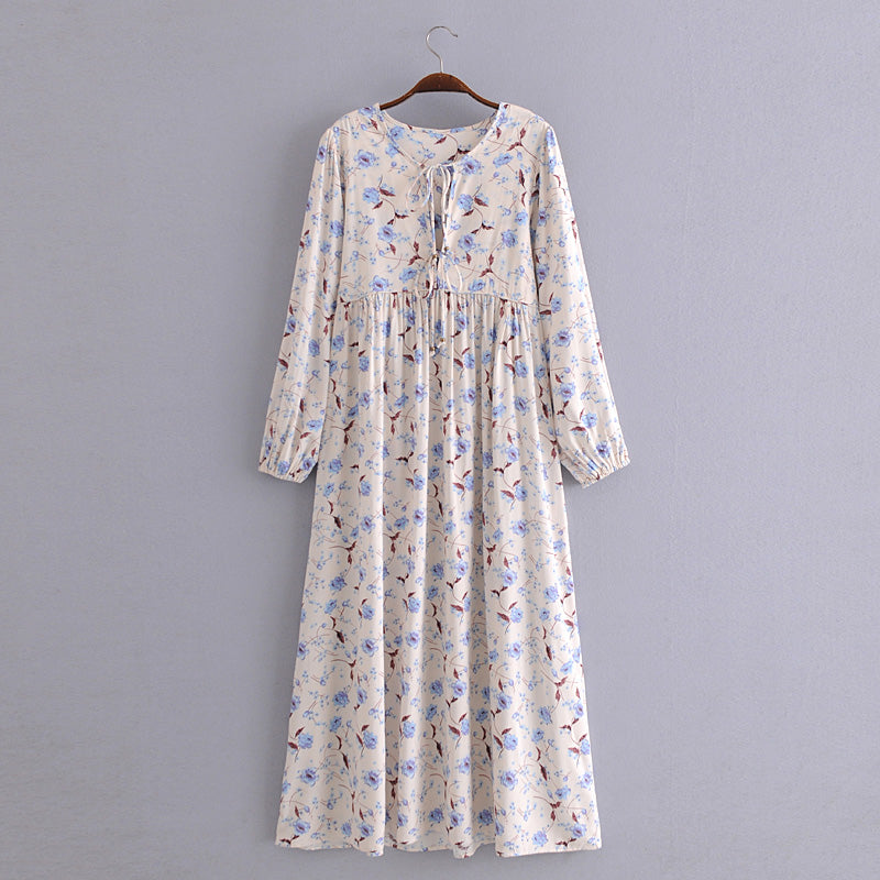 Elegant floral maxi dress in cream with blue and brown flower print and long sleeves by Malbusaat