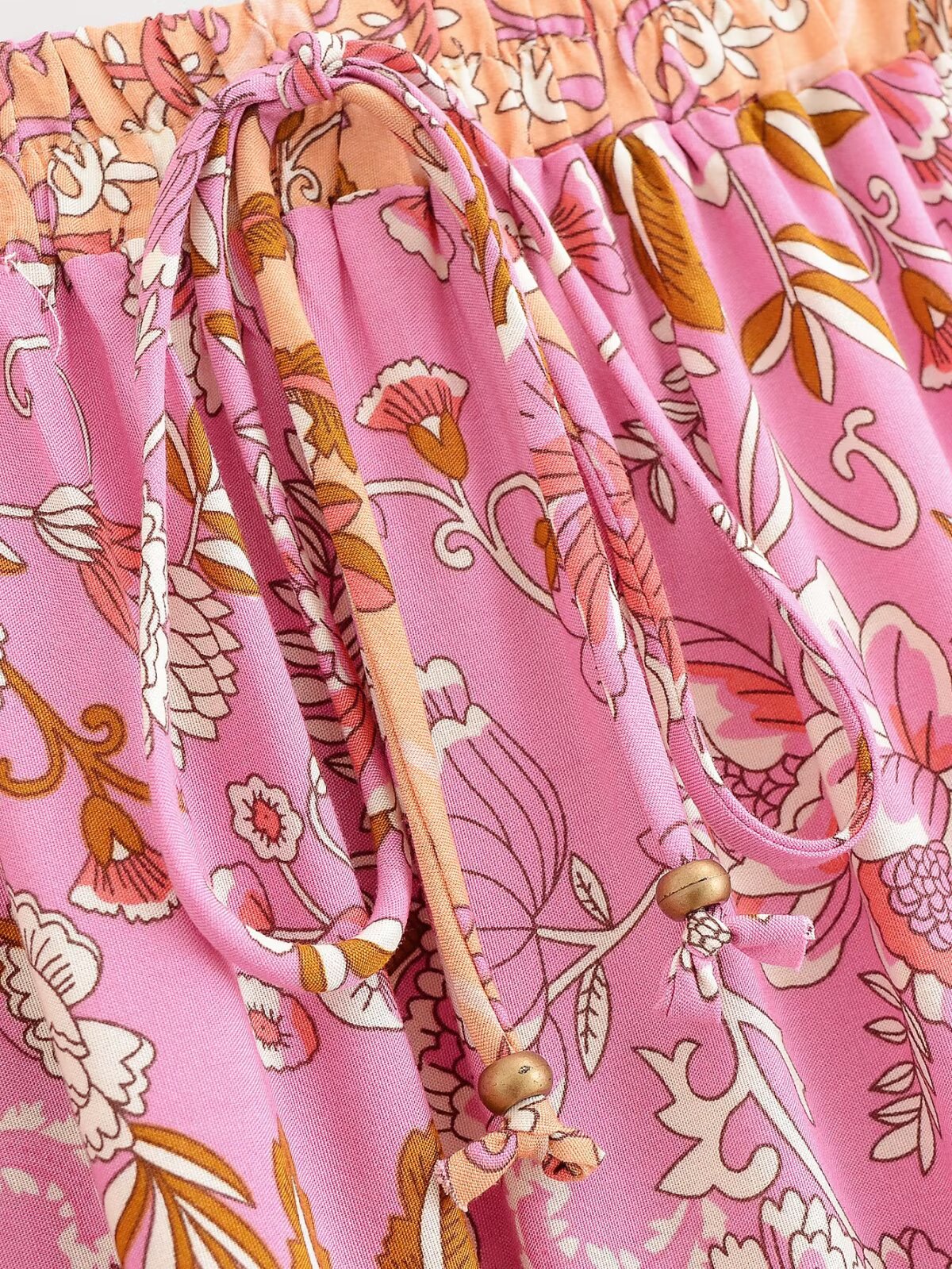 Close-up of Malbusaat elastic waist floral skirt UK in pink with detailed floral print and adjustable ties