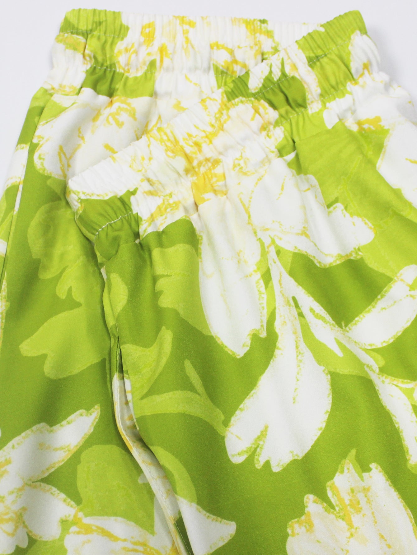 Green and white floral fabric detail of short sleeved ladies jumpsuit outfit by Malbusaat