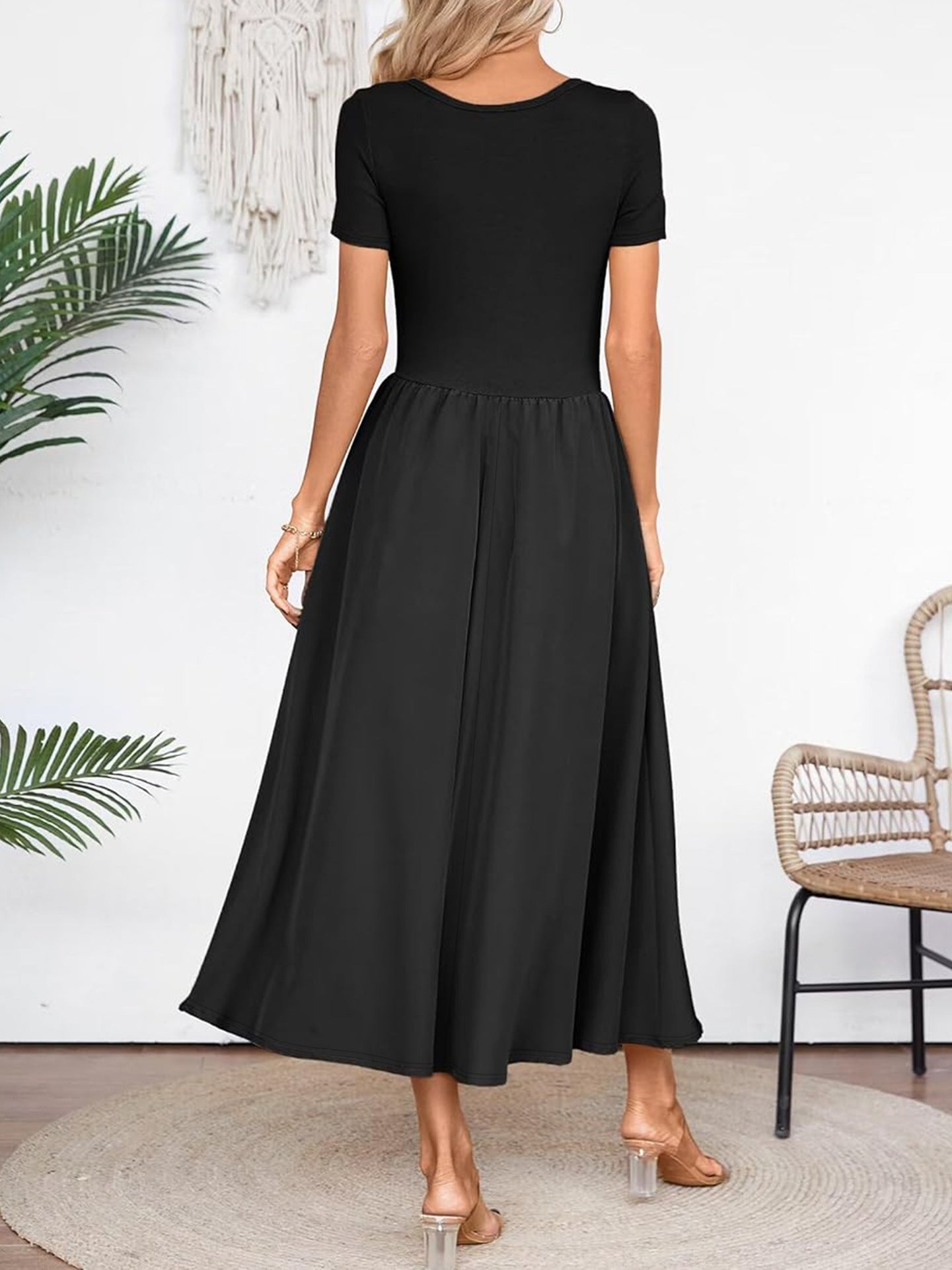 Back view of elegant black midi dress for summer with short sleeves and flowing skirt