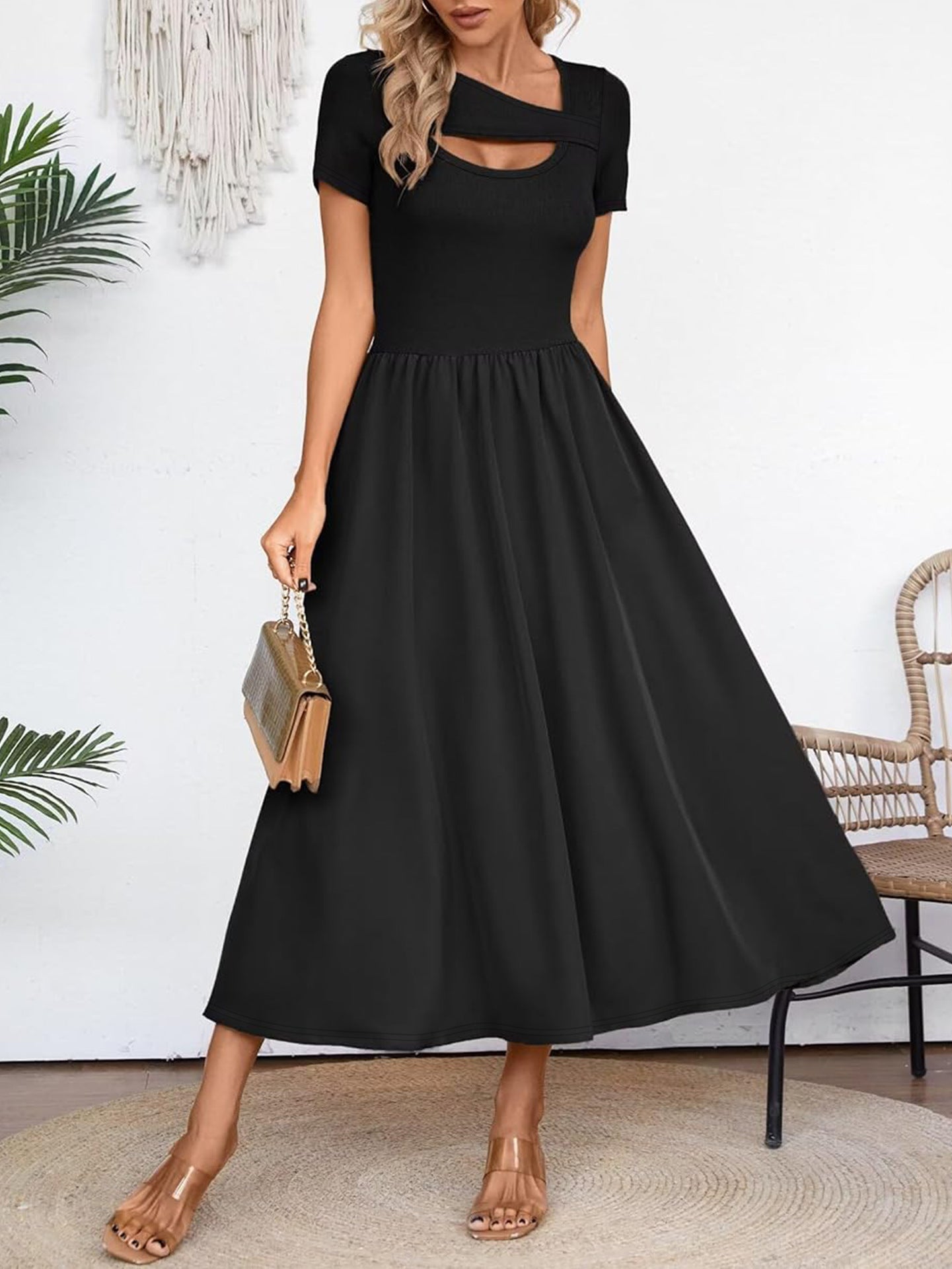 Elegant black midi dress for summer with short sleeves and cutout detail, styled with nude sandals and a handbag