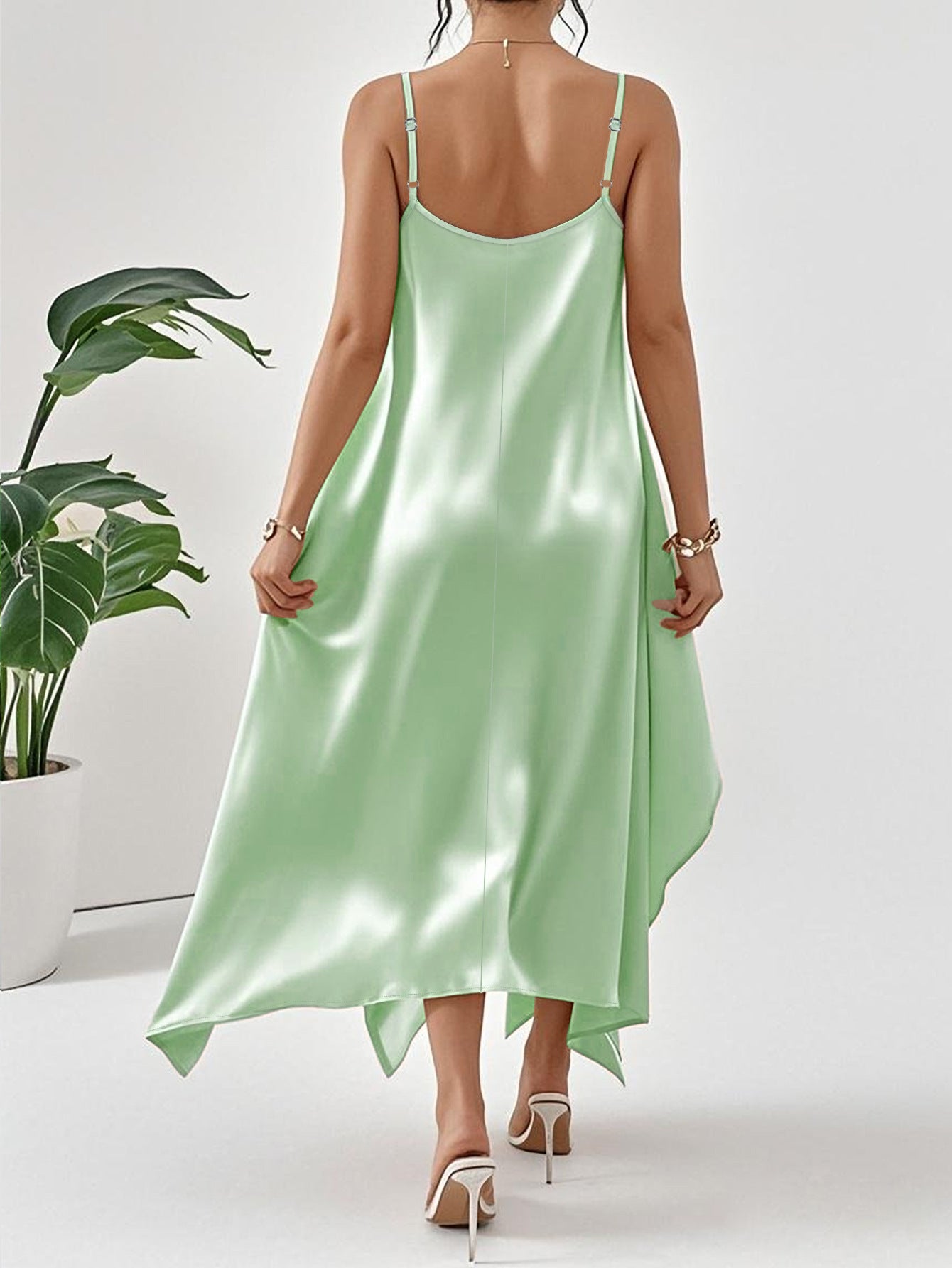 Back view of elegant long sling dress for women in shiny mint green satin fabric by Malbusaat