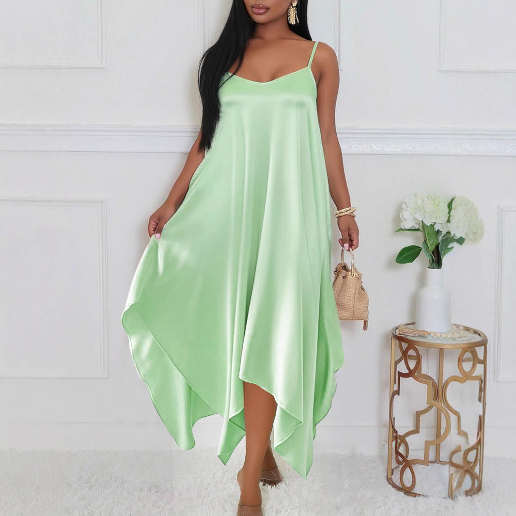 Elegant long sling dress for women in light green satin fabric styled with minimal accessories