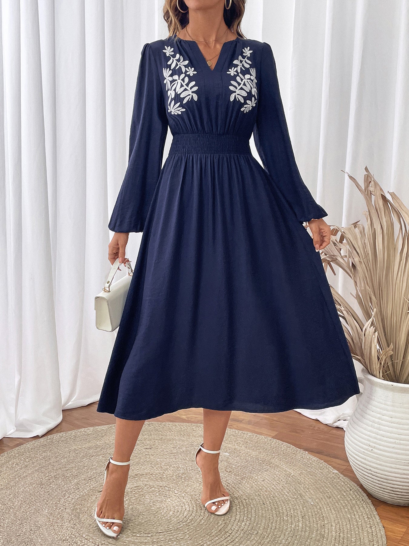 Navy embroidered v neck midi dress with long sleeves and floral detailing, perfect for casual outings