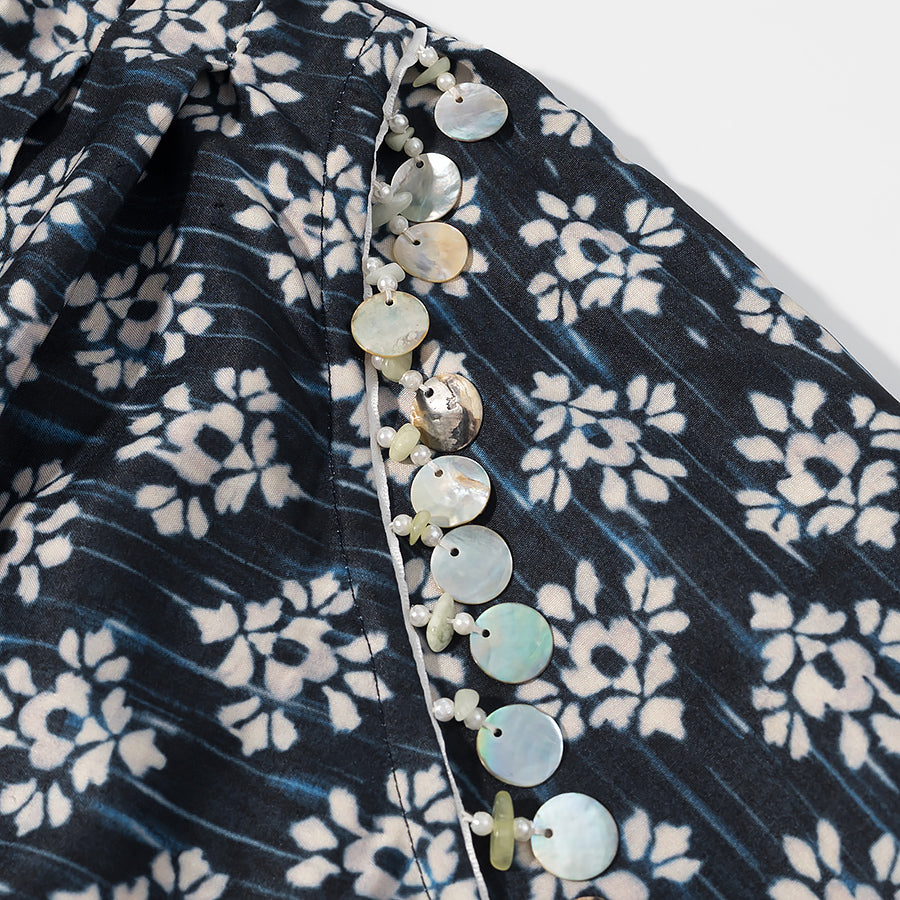 Close-up of black and white floral patterned Malbusaat fashionable beaded skirts for women with round bead embellishments