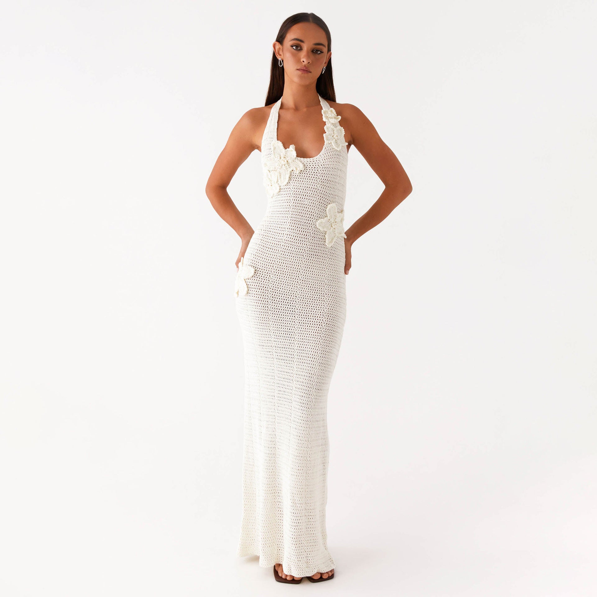 Malbusaat white crochet halter gown with three dimensional flower appliques and side cutouts floral cutout maxi dress