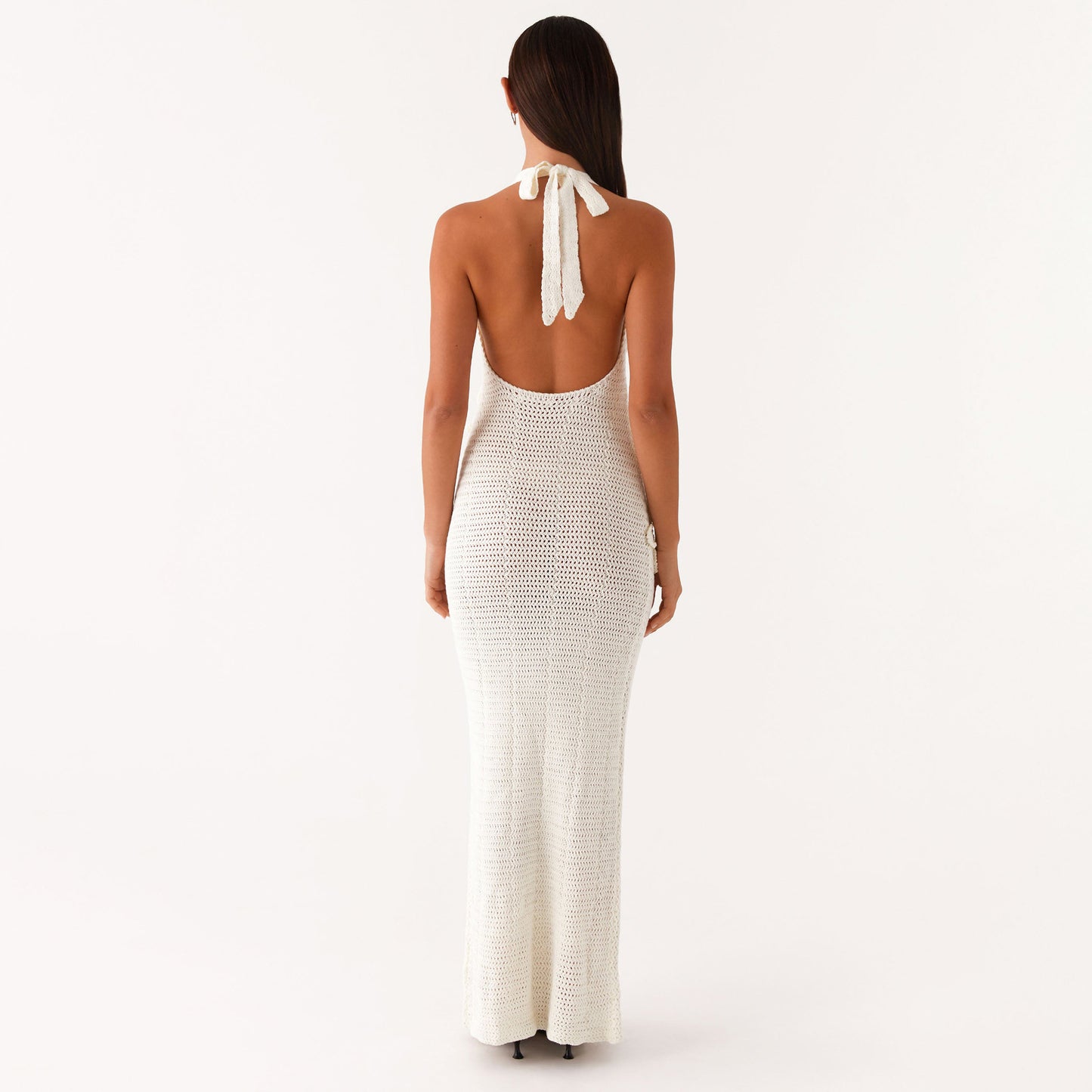 Malbusaat white crochet halter open back gown showing floral cutout maxi dress silhouette and floor length
