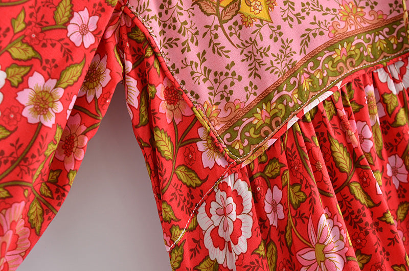 Close-up of Malbusaat spring long sleeve maxi dress with red floral print and detailed stitching